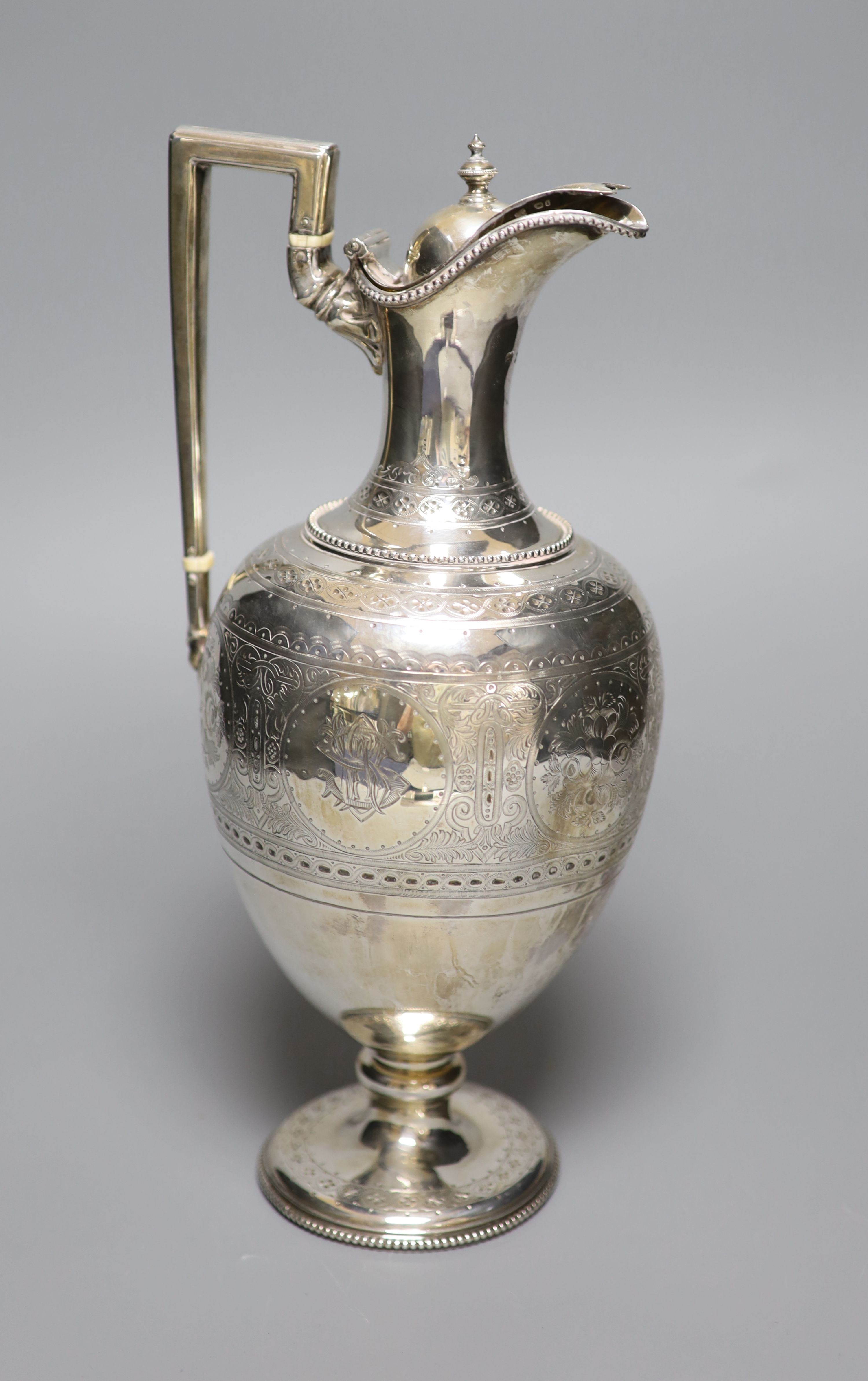 A Victorian engraved silver baluster hot water jug, Martin, Hall & Co, London, 1874